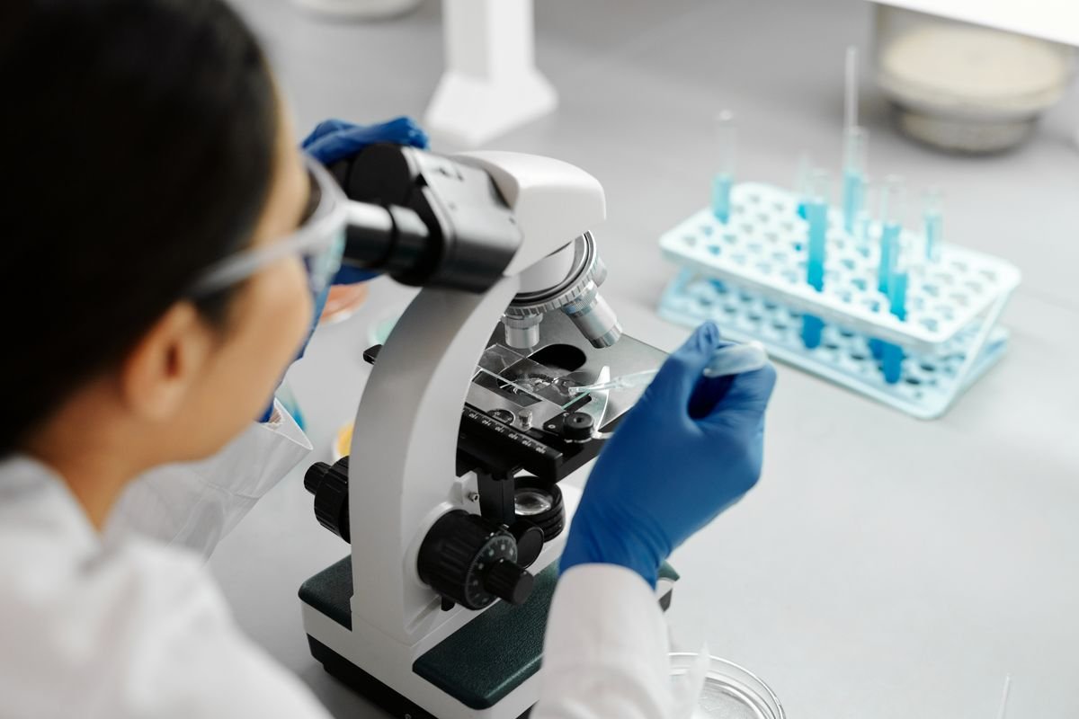 Biomedical engineering student conducting microscope research